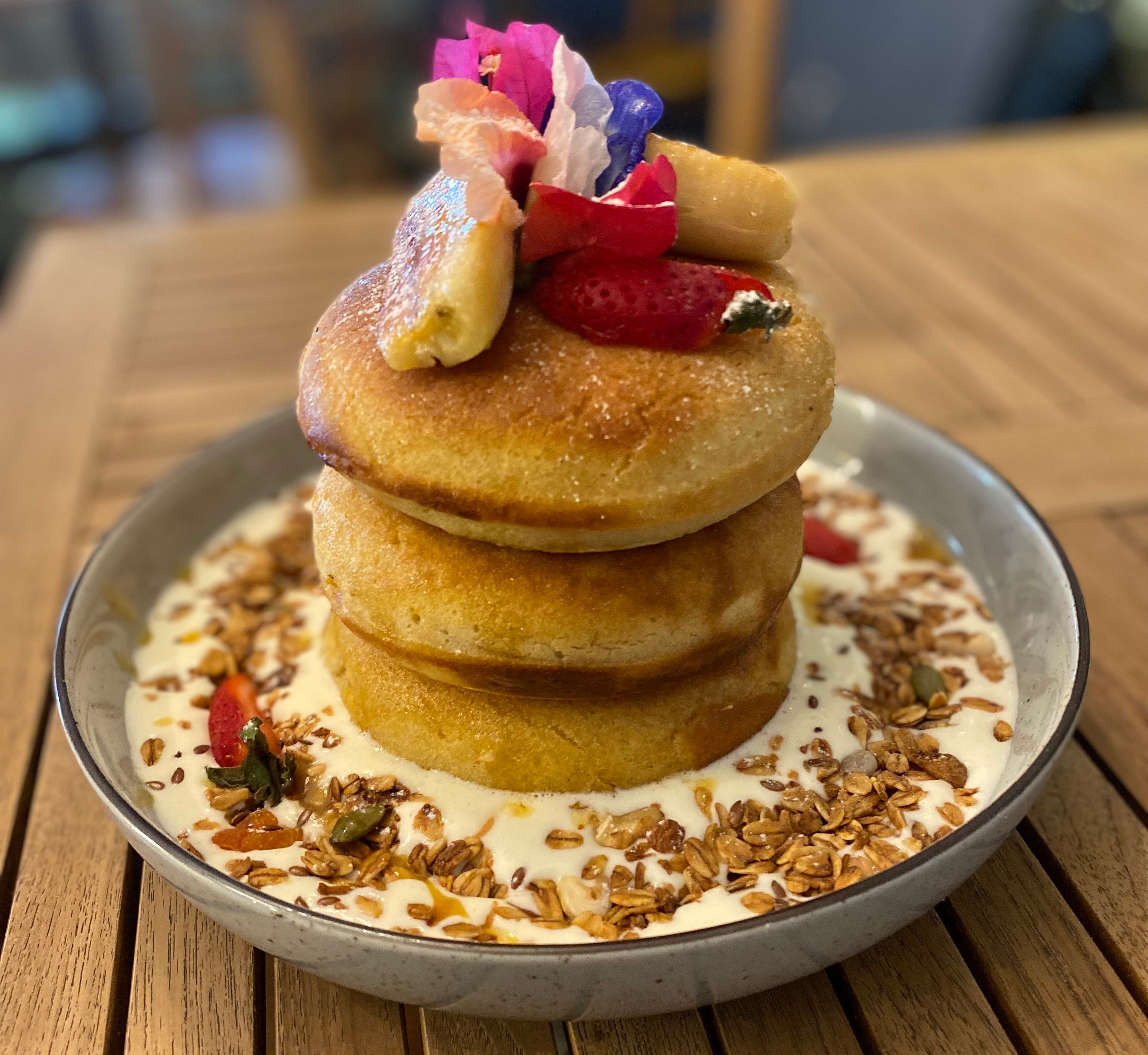 Pancake stack with fruit and granola.