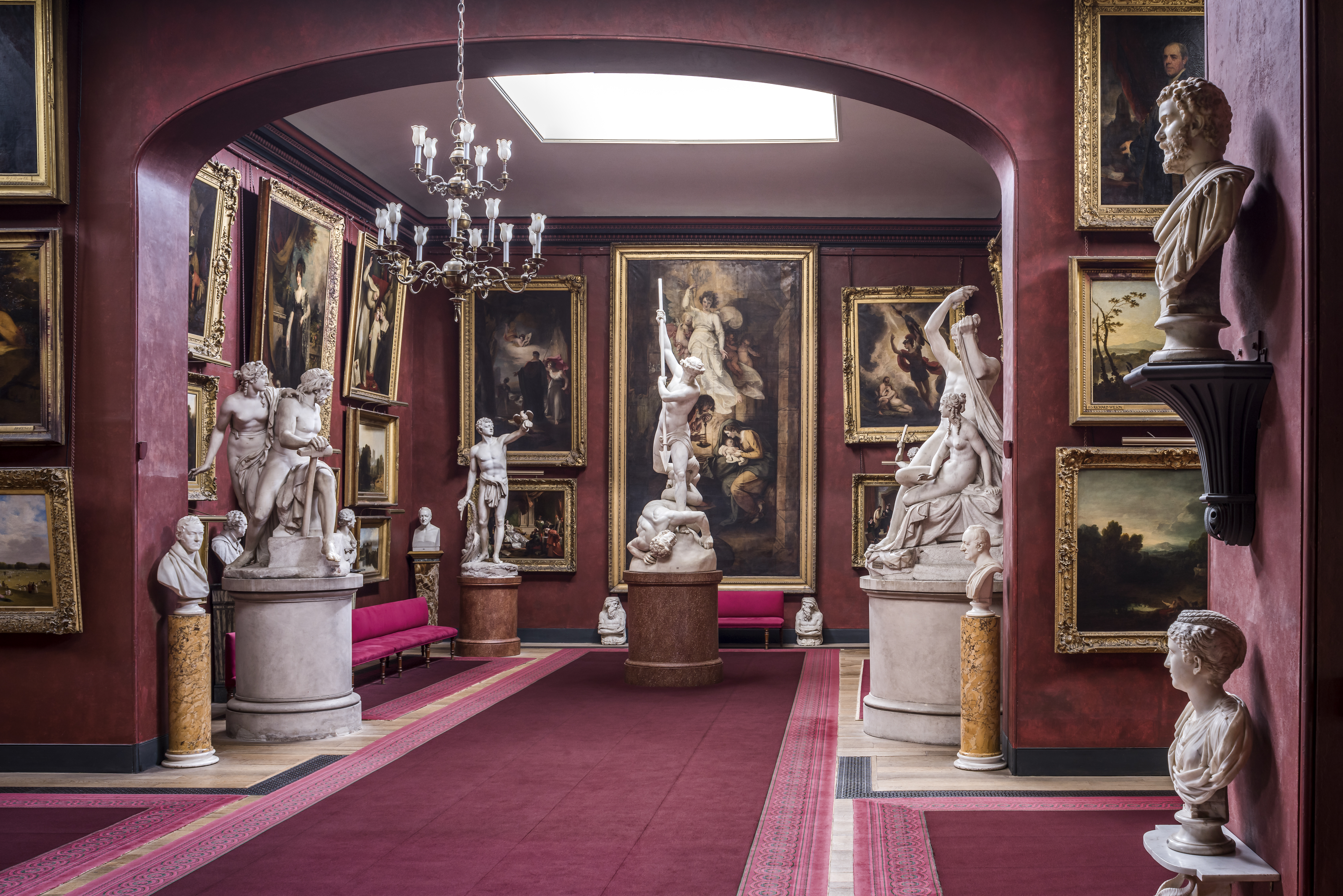 The North Gallery at Petworth House, featuring classical sculptures and historical paintings.