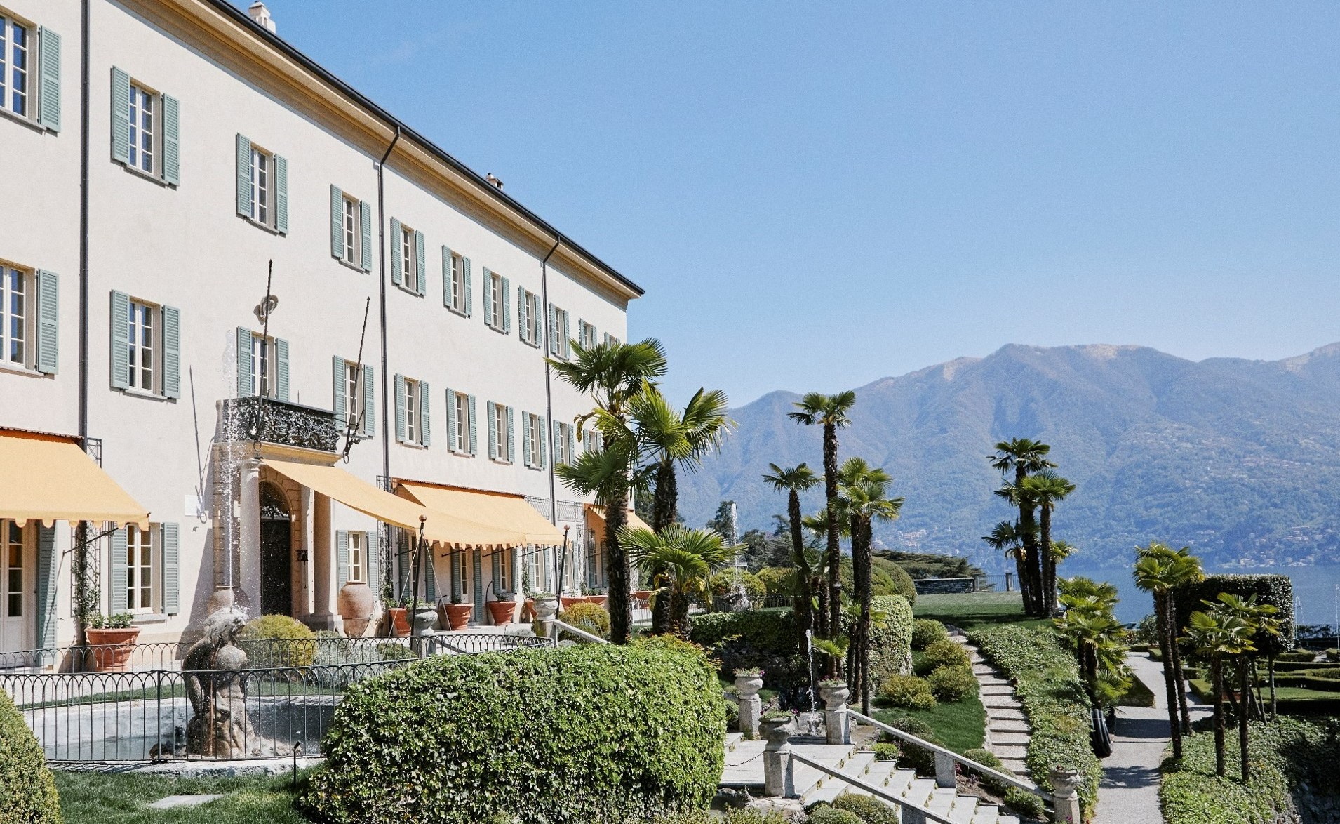 Passalacqua building with palm trees and gardens.