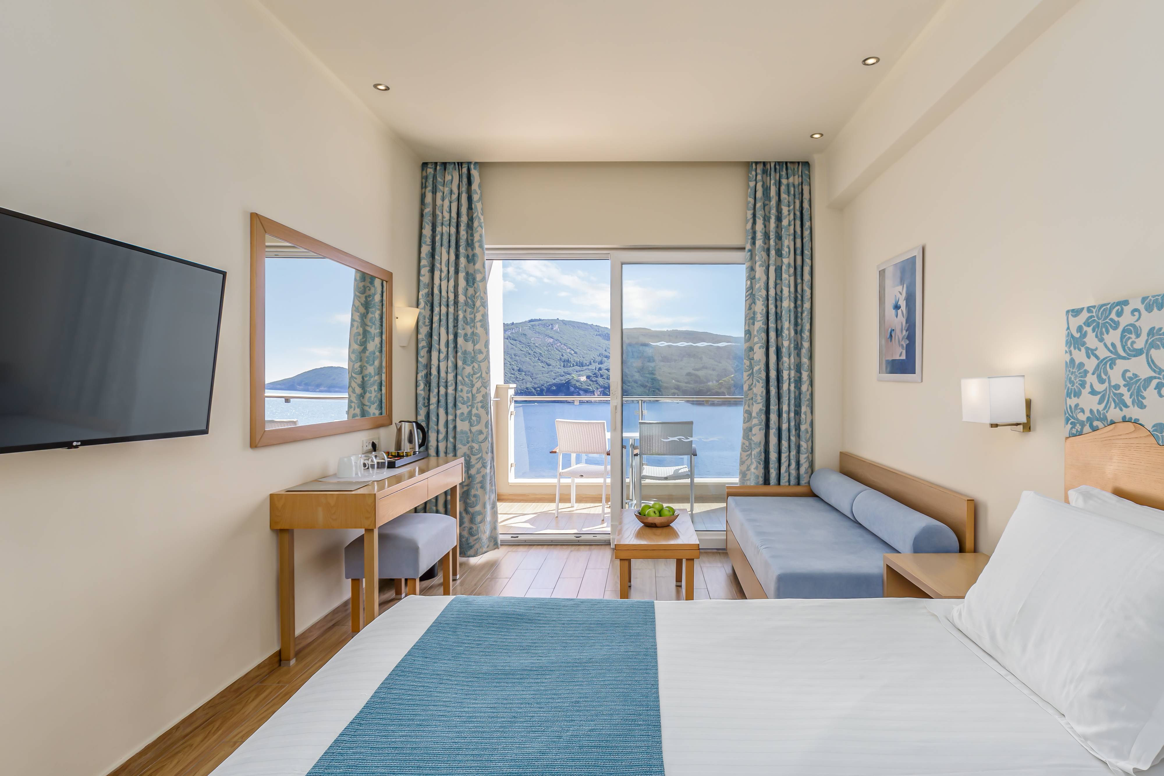 A guest room with a view of the sea at Akrotiri Beach Resort Hotel in Corfu
