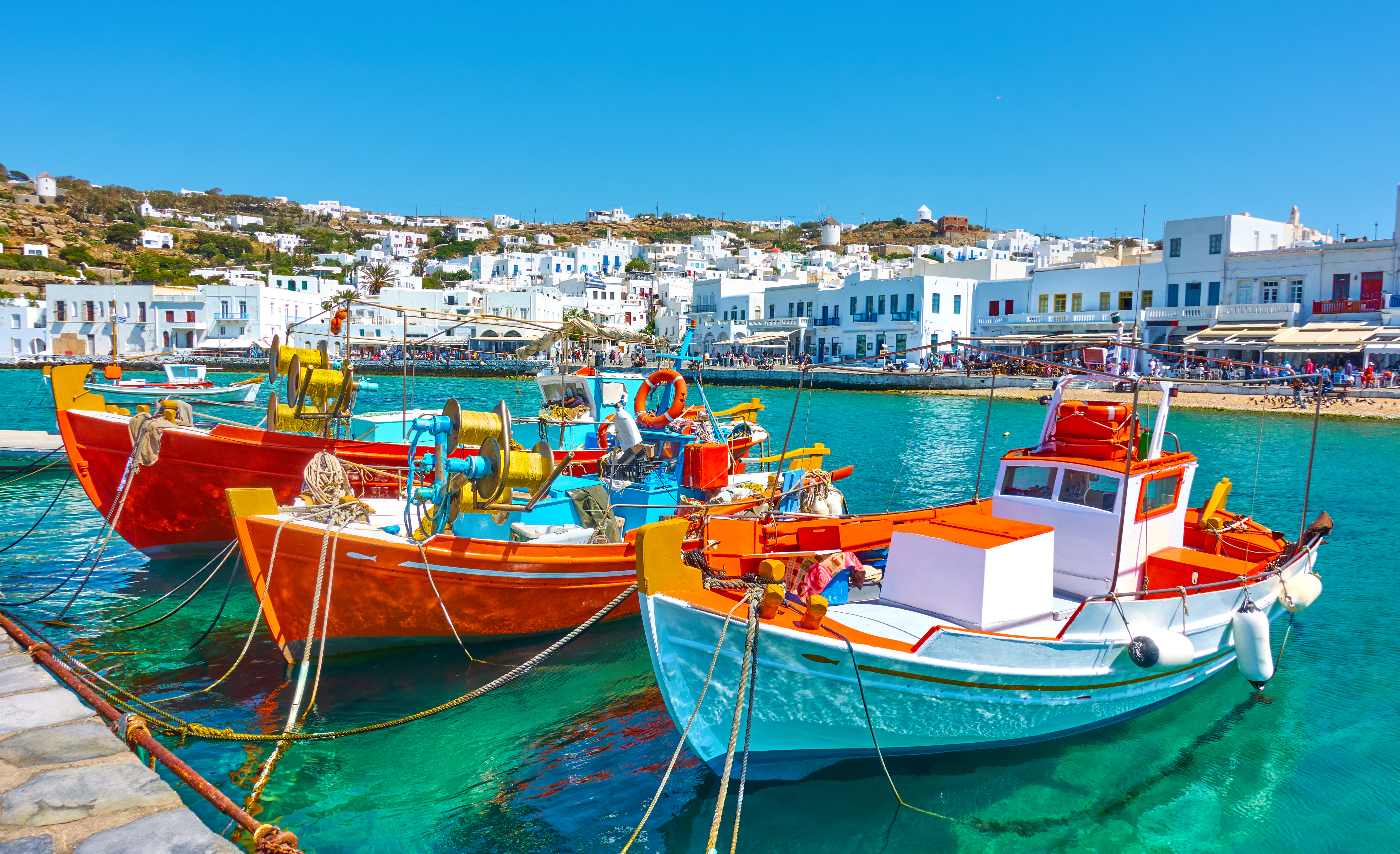 Colorful fishing boats in a Mykonos harbor.